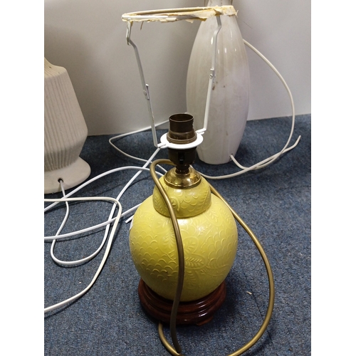 71 - A group of three electric table lamps comprising two white marble-effect baluster lamps with pleated... 