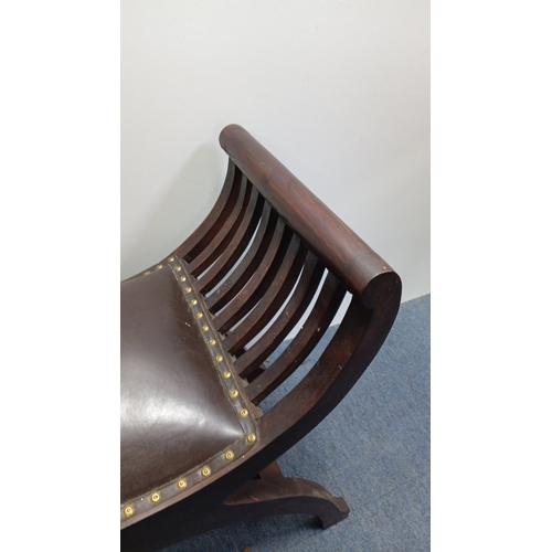 119 - A vintage curved mahogany bench, the bowed ends with arched slatwork rising to cylindrical crest rai... 