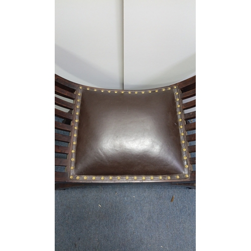 119 - A vintage curved mahogany bench, the bowed ends with arched slatwork rising to cylindrical crest rai... 