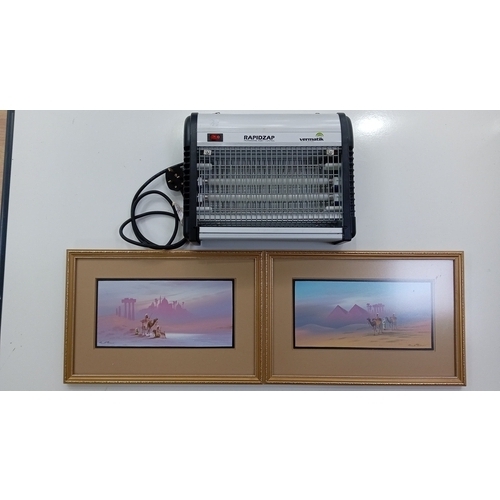 104 - A group of two framed original gouache paintings by Frank Holmes depicting stylised Arabic desert sc... 
