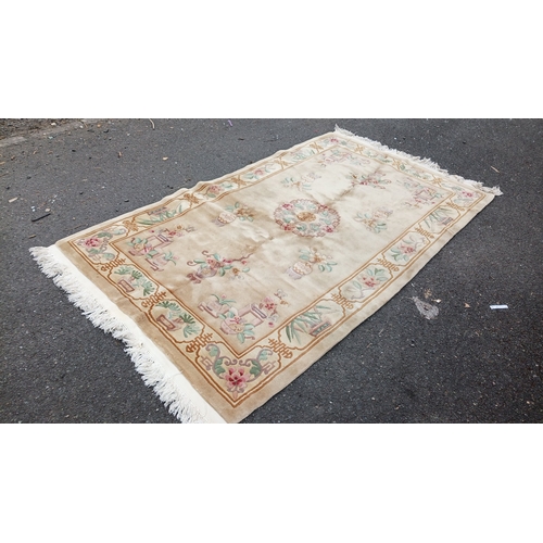 78 - Chinese-style pictorial carpet, the beige field with scattered floral sprigs and a central roundel. ... 