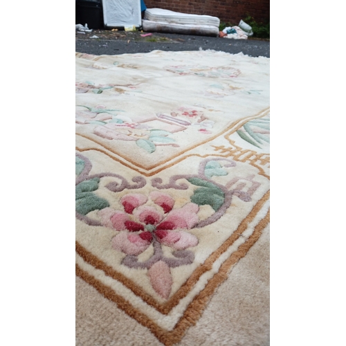 78 - Chinese-style pictorial carpet, the beige field with scattered floral sprigs and a central roundel. ... 