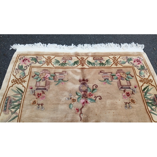 78 - Chinese-style pictorial carpet, the beige field with scattered floral sprigs and a central roundel. ... 