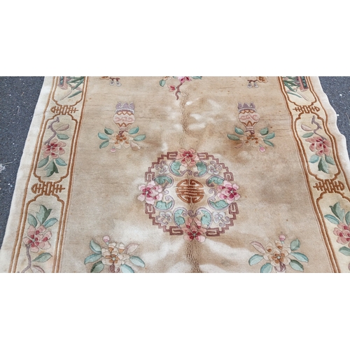 78 - Chinese-style pictorial carpet, the beige field with scattered floral sprigs and a central roundel. ... 