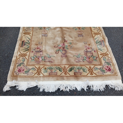 78 - Chinese-style pictorial carpet, the beige field with scattered floral sprigs and a central roundel. ... 