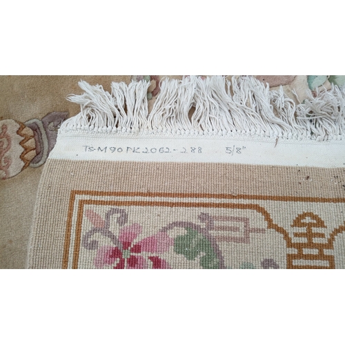 78 - Chinese-style pictorial carpet, the beige field with scattered floral sprigs and a central roundel. ... 