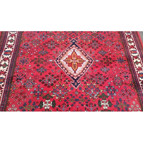79 - Persian-style wool rug with scattered geometric and stylised floral motifs, and stepped corner spand... 