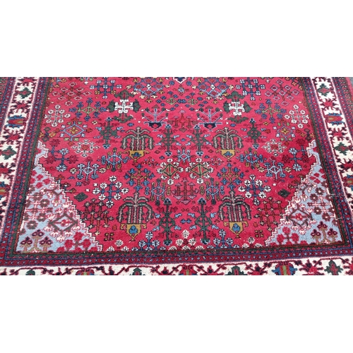 79 - Persian-style wool rug with scattered geometric and stylised floral motifs, and stepped corner spand... 