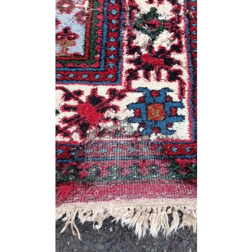 79 - Persian-style wool rug with scattered geometric and stylised floral motifs, and stepped corner spand... 