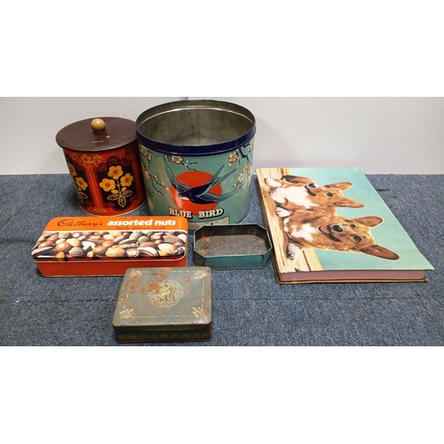 82 - An assortment of vintage printed tin containers including a Cadbury’s assorted nuts tin, a large “Bl... 