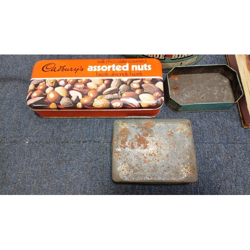 82 - An assortment of vintage printed tin containers including a Cadbury’s assorted nuts tin, a large “Bl... 