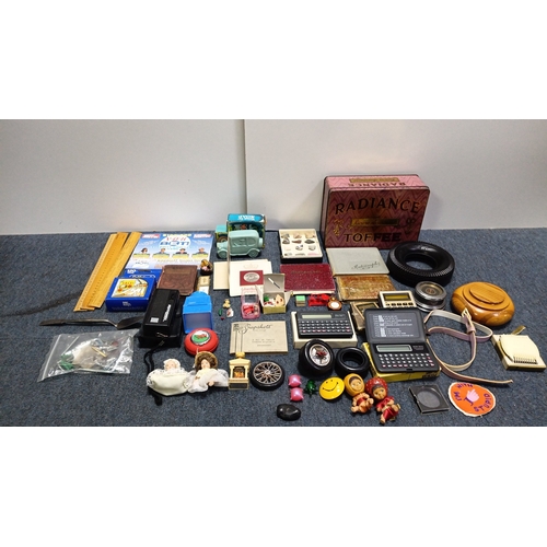 83 - An assortment of small collectibles and ephemera including a Radiance Toffee tin, rulers, novelty to... 