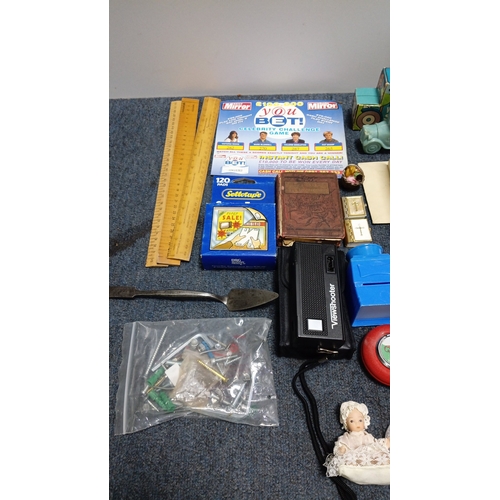 83 - An assortment of small collectibles and ephemera including a Radiance Toffee tin, rulers, novelty to... 