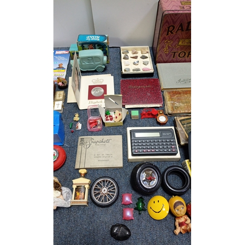 83 - An assortment of small collectibles and ephemera including a Radiance Toffee tin, rulers, novelty to... 