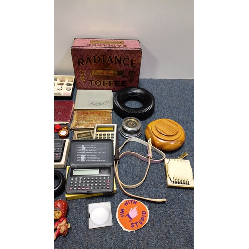 83 - An assortment of small collectibles and ephemera including a Radiance Toffee tin, rulers, novelty to... 