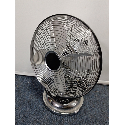 85 - A group of domestic electricals comprising a chrome-effect oscillating table fan with wire guard, He... 