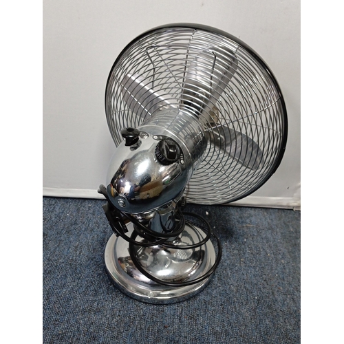 85 - A group of domestic electricals comprising a chrome-effect oscillating table fan with wire guard, He... 