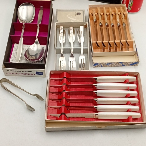 88 - A group of mid-20th-century flatware and cutlery, including a OneidaCraft stainless-steel salad serv... 