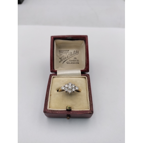 382 - A .750 stamped 18ct gold ring featuring 9 diamonds with box.(Size O) Weight 3.75 Grams.