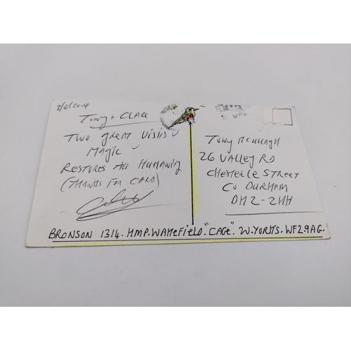 106 - A signed Charles Bronson postcard featuring drawings 