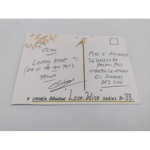 107 - A signed Charles Bronson postcard featuring drawings 