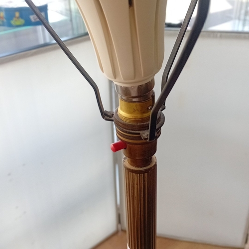 98 - Mid-20th century brass standard lamp, the fluted column with black painted reserves decorated with g... 