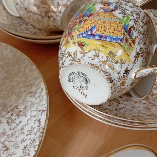 26 - Empire England bone china part tea service, decorated with gilt floral scrollwork and polychrome pas... 