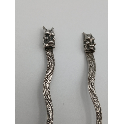 239 - A set of four tested silver dragon spoons depicting a bird on a lotus tree.