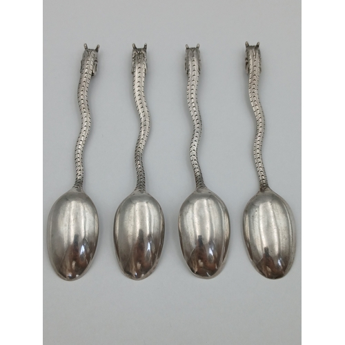 239 - A set of four tested silver dragon spoons depicting a bird on a lotus tree.