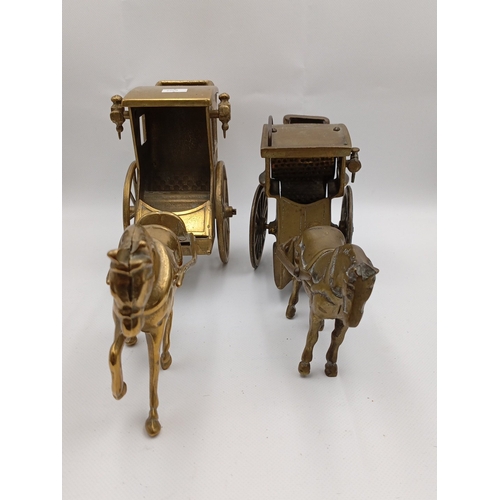 5 - A pair of brass horse-drawn carriage models, each with canopy, glazed windows, spoked wheels and har... 