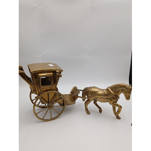 5 - A pair of brass horse-drawn carriage models, each with canopy, glazed windows, spoked wheels and har... 