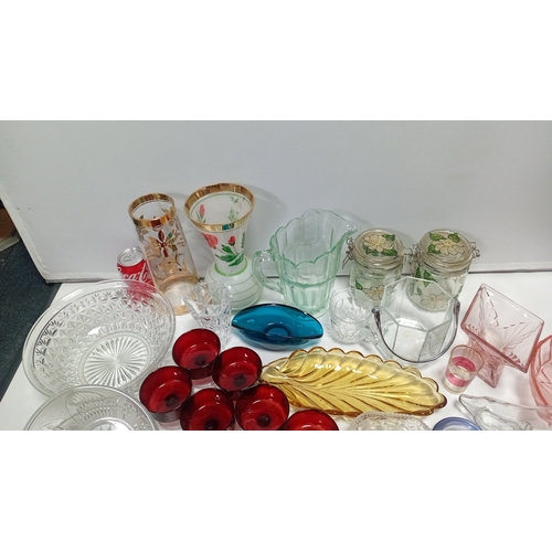 9 - A group of 20th century glass tablewares comprising moulded clear pressed bowls, ruby glass compotes... 