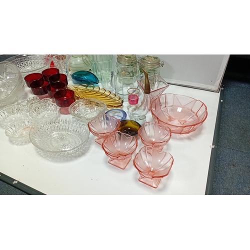 9 - A group of 20th century glass tablewares comprising moulded clear pressed bowls, ruby glass compotes... 