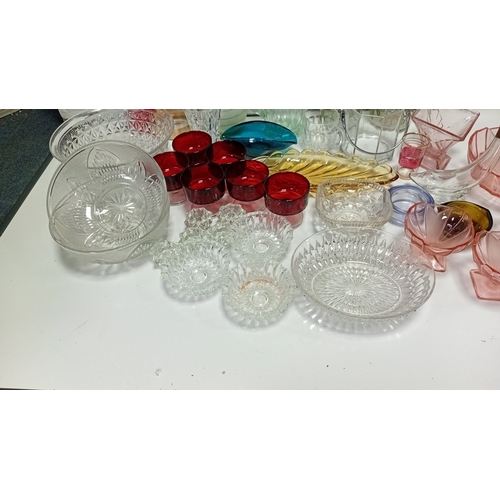 9 - A group of 20th century glass tablewares comprising moulded clear pressed bowls, ruby glass compotes... 