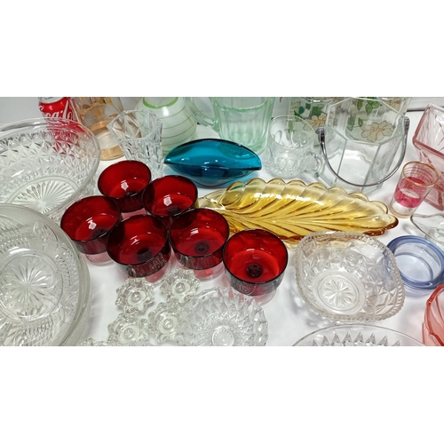 9 - A group of 20th century glass tablewares comprising moulded clear pressed bowls, ruby glass compotes... 