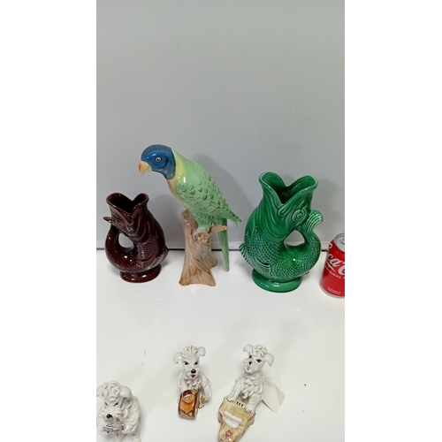 10 - A group of glazed ceramic animal figures and novelty wares, including a model cow, perched parrot, t... 