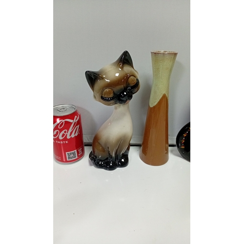 11 - A group of glazed ceramic animal figures comprising two Siamese-style cats, a black cat, a stylised ... 
