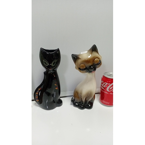 11 - A group of glazed ceramic animal figures comprising two Siamese-style cats, a black cat, a stylised ... 