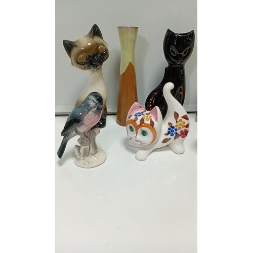11 - A group of glazed ceramic animal figures comprising two Siamese-style cats, a black cat, a stylised ... 