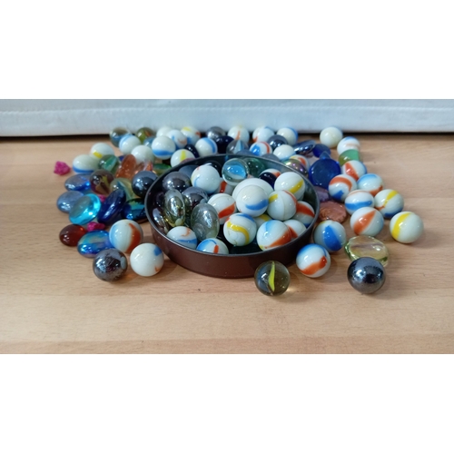 14 - A group of assorted glass marbles and glass stones, including opaque and transparent examples with c... 