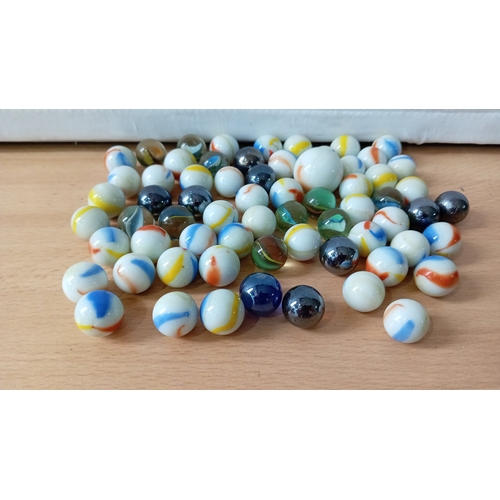 14 - A group of assorted glass marbles and glass stones, including opaque and transparent examples with c... 