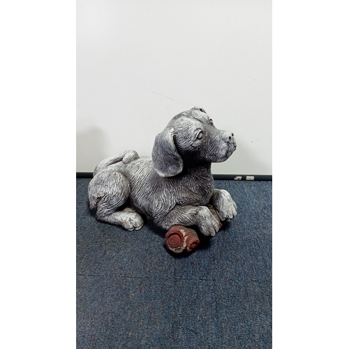 22 - A group of two composite garden ornaments modelled as dogs: one seated terrier-type figure and one r... 