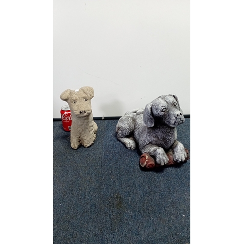 22 - A group of two composite garden ornaments modelled as dogs: one seated terrier-type figure and one r... 