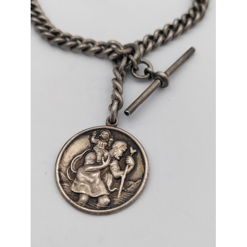 390 - A hallmarked silver Albert chain with hallmarked T bar and St Christopher pendant.