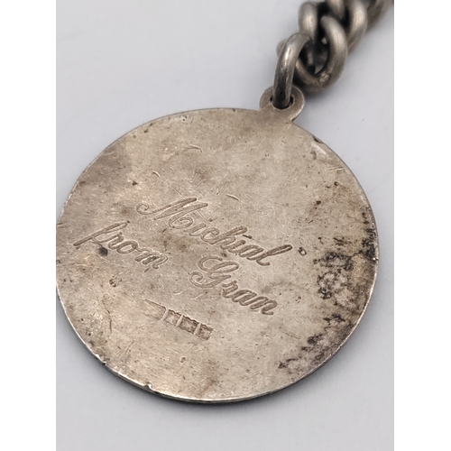 390 - A hallmarked silver Albert chain with hallmarked T bar and St Christopher pendant.