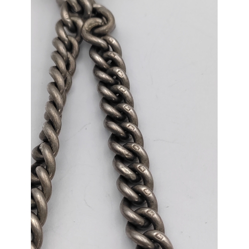 390 - A hallmarked silver Albert chain with hallmarked T bar and St Christopher pendant.