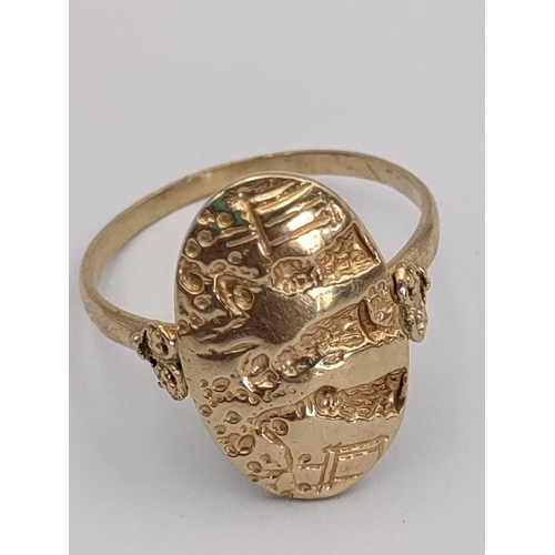 393 - A stamped 585 14ct gold signet ring. With detailed engravings and heart mounts. Size U. 3.74 grams.