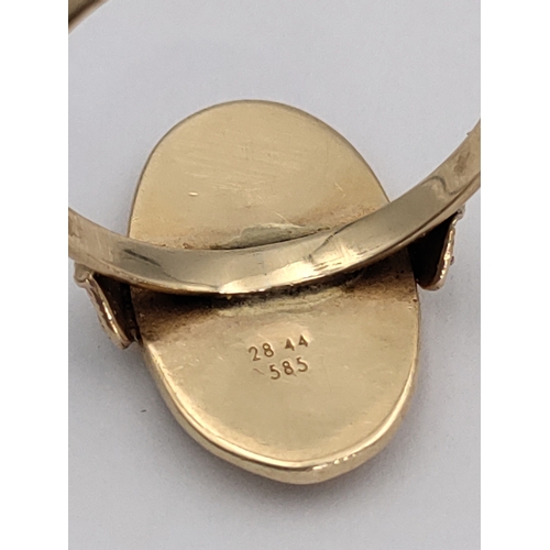 393 - A stamped 585 14ct gold signet ring. With detailed engravings and heart mounts. Size U. 3.74 grams.
