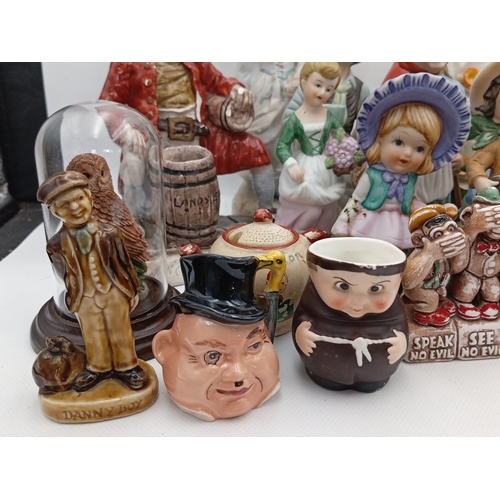 23 - A quantity of painted ceramic and resin figural ornaments, including rustic characters, child figure... 