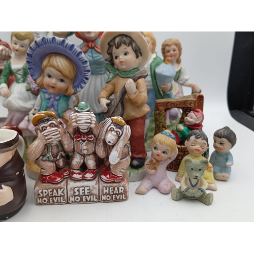 23 - A quantity of painted ceramic and resin figural ornaments, including rustic characters, child figure... 